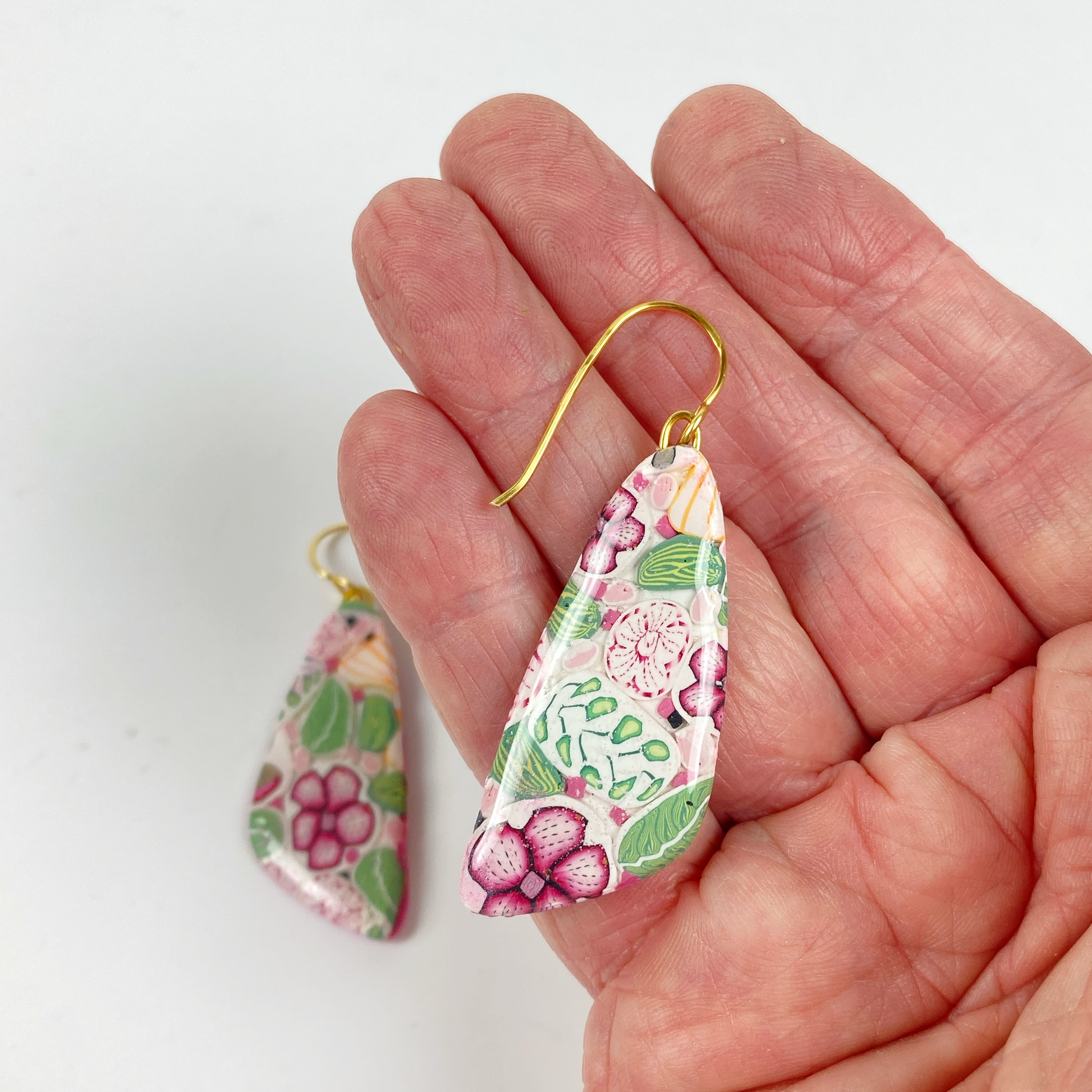 Pink Woodlands Handmade Polymer Clay Drop Earrings handheld for size reference