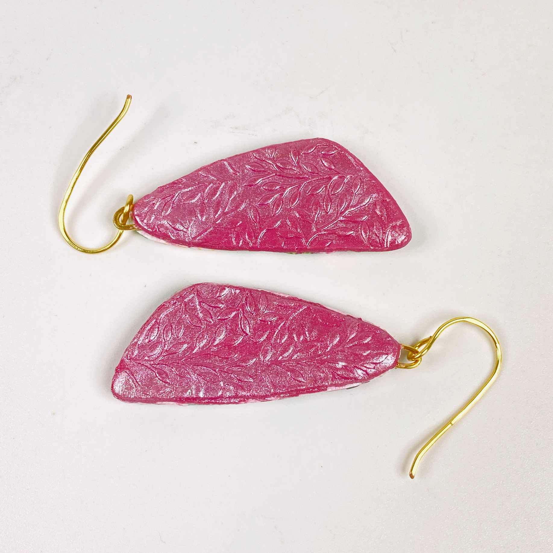 Pink Woodlands Handmade Polymer Clay Drop Earrings showing the embossed pink backing