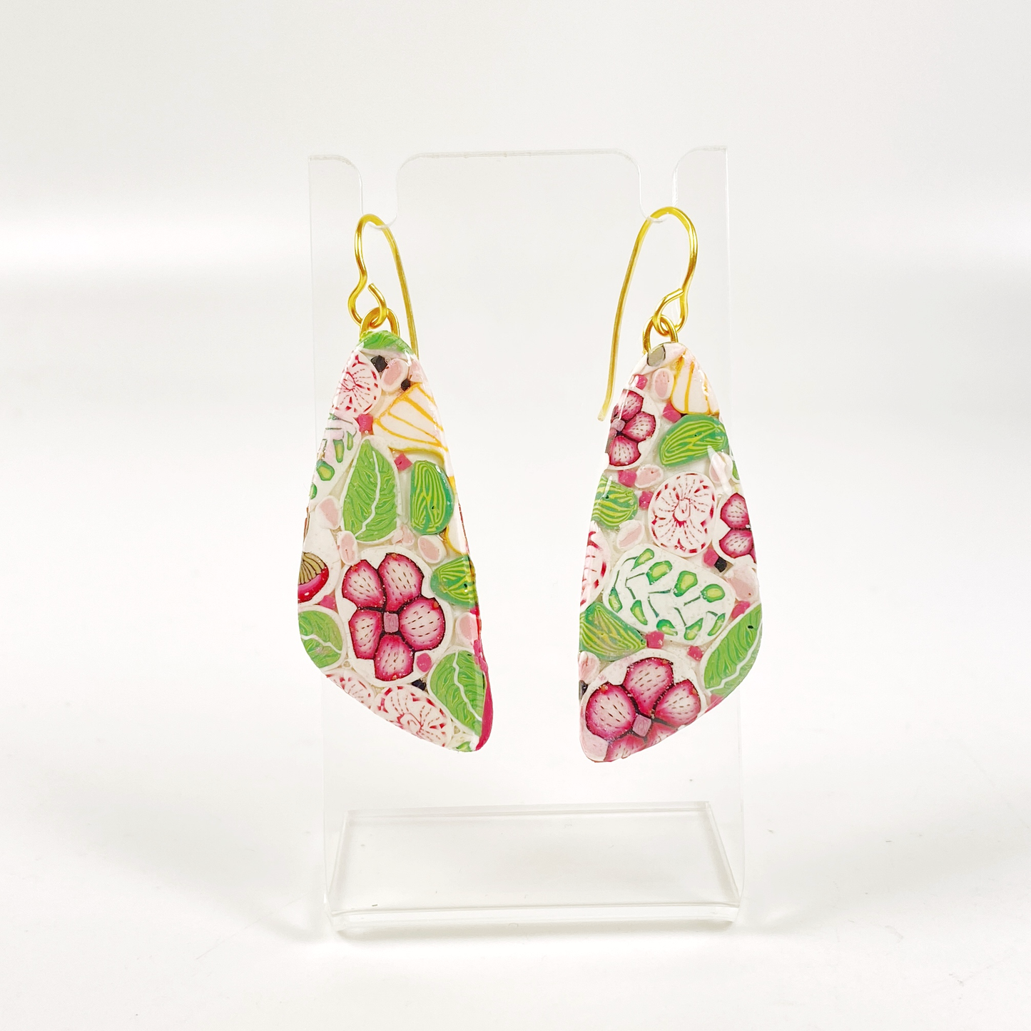 Pink Woodlands Handmade Polymer Clay Drop Earrings on a small clear earring stand