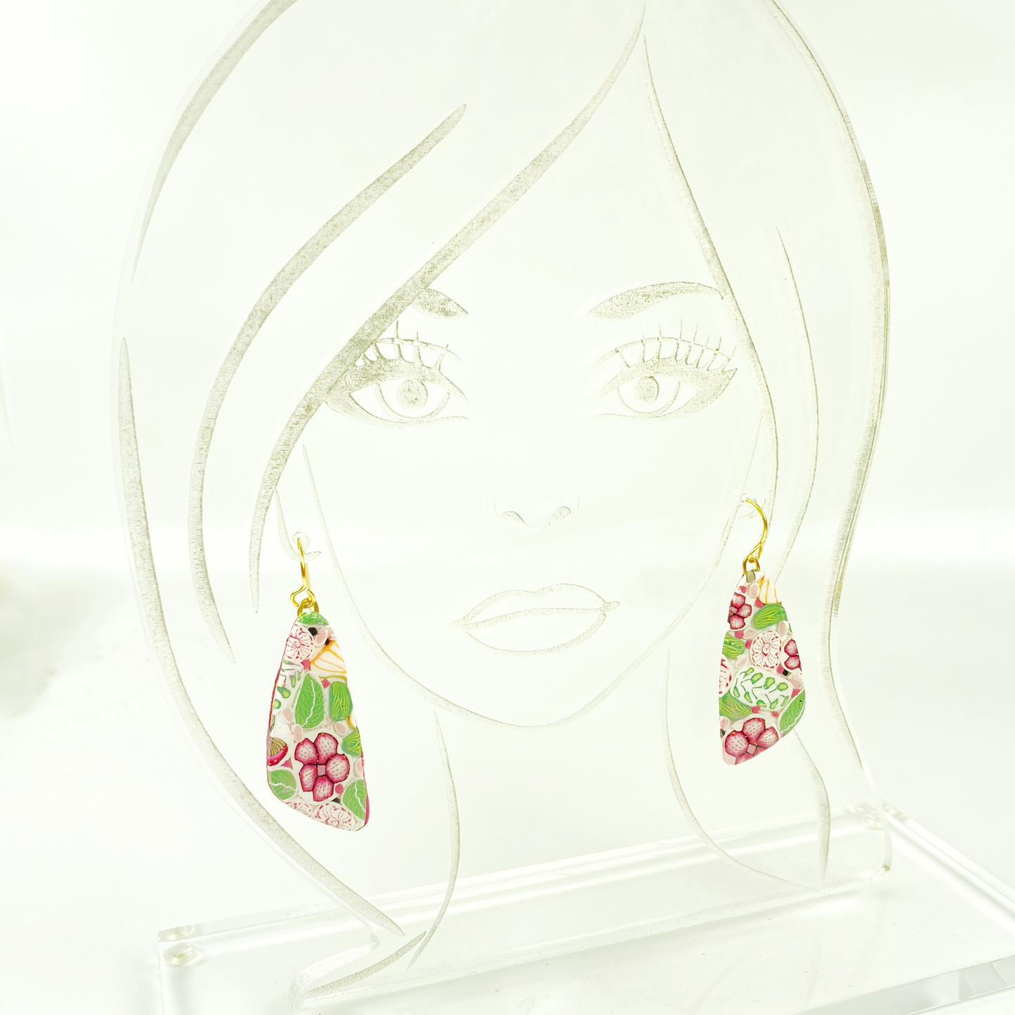 Pink Woodlands Handmade Polymer Clay Drop Earrings on a clear acrylic display head