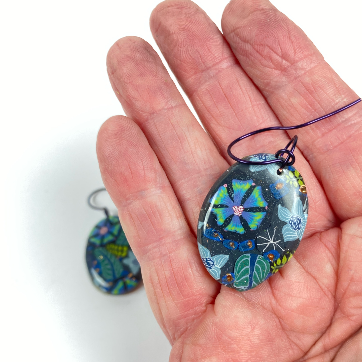 Night Blossom Handmade Polymer Clay Dangle Earrings II handheld for size reference