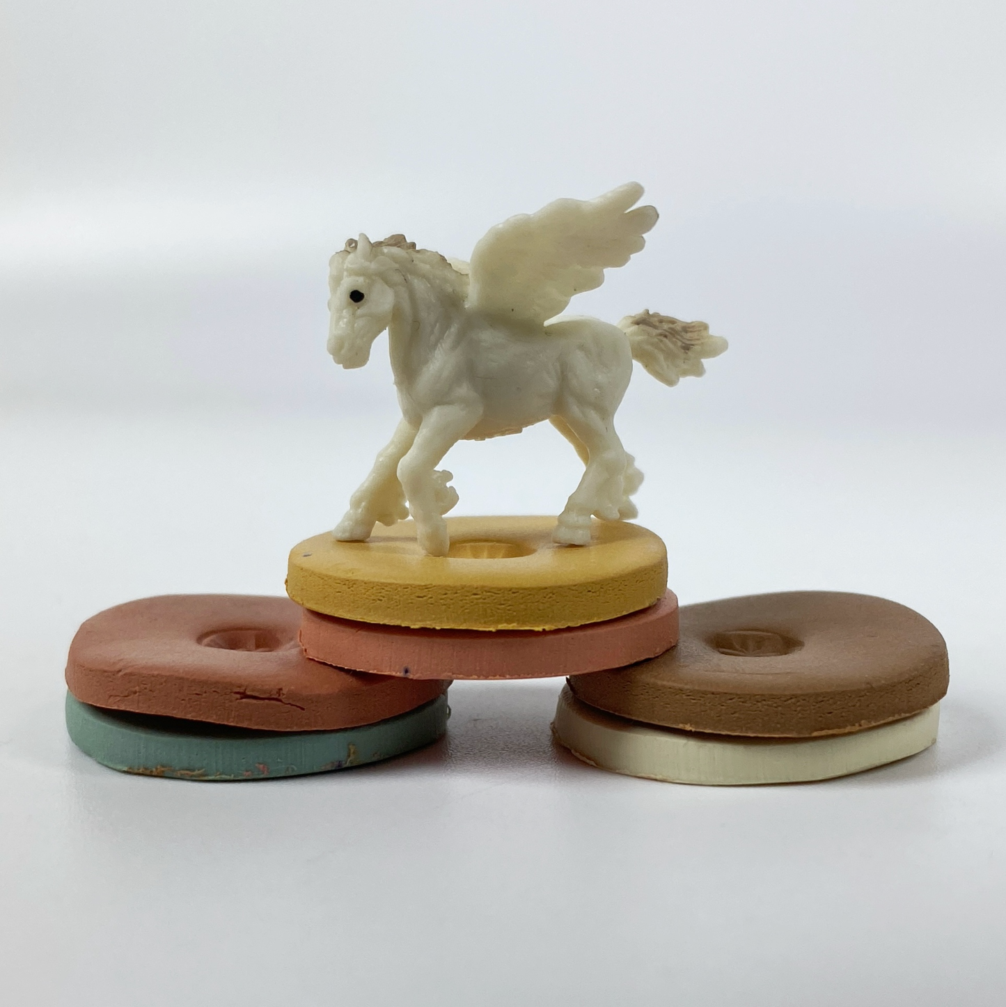 Portrait of a Lady Palette Polymer Clay Color Mixing Tutorial , a little white pegasus posing with the clay sample color discs.