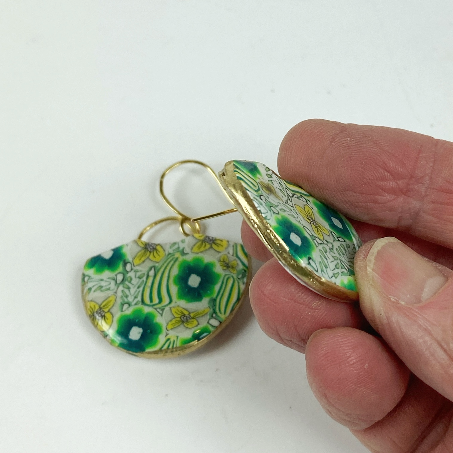 Green Flower Handmade Polymer Clay Earrings showing the gold-toned edges