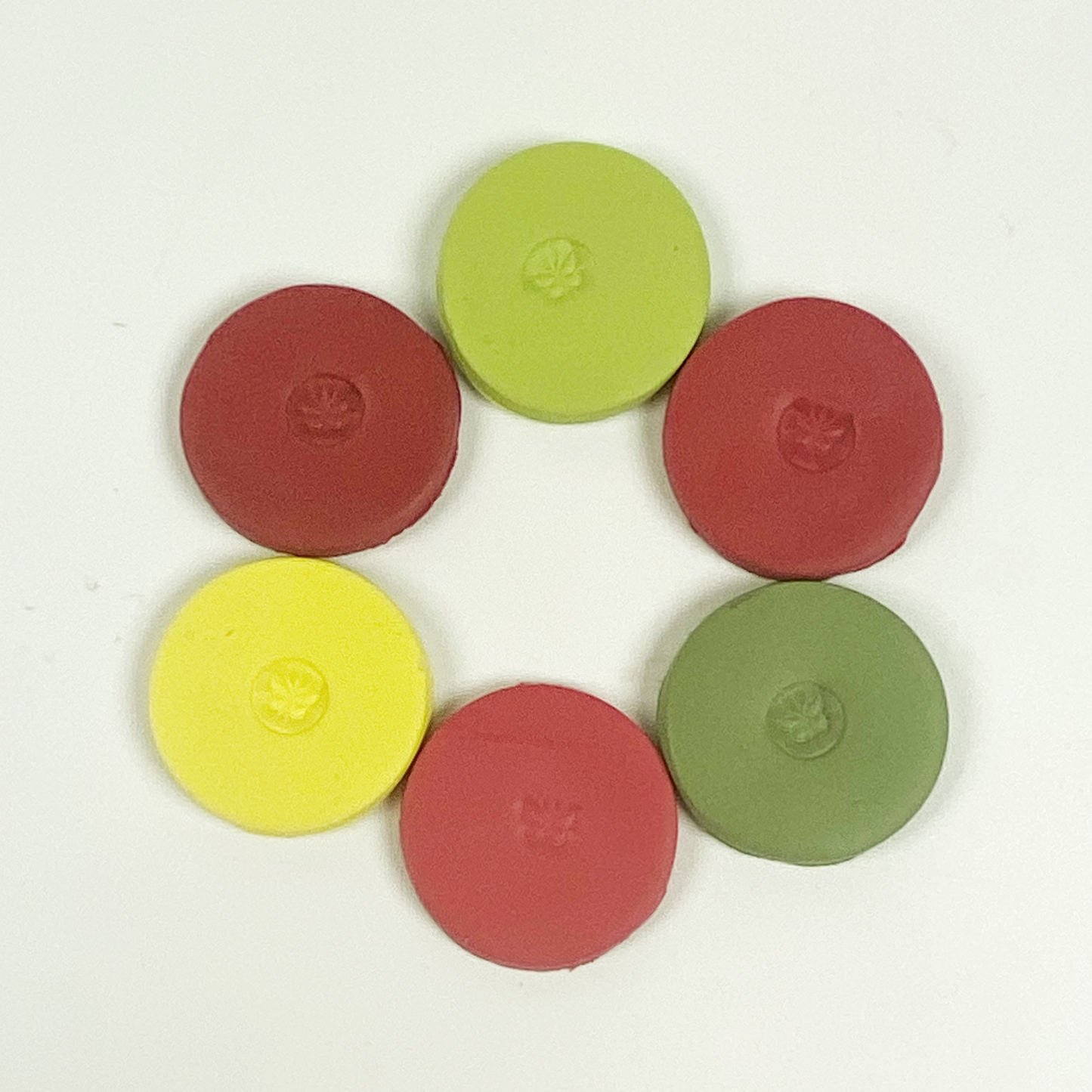 Discs of Polymer Clay in all 6 apple colors of this palette, arranged in a ring.