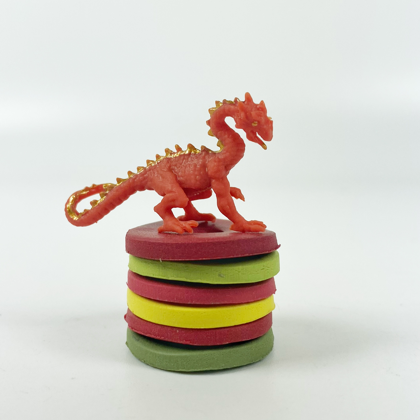 Stacked discs of each polymer clay color in this palette guarded by a red dragon!