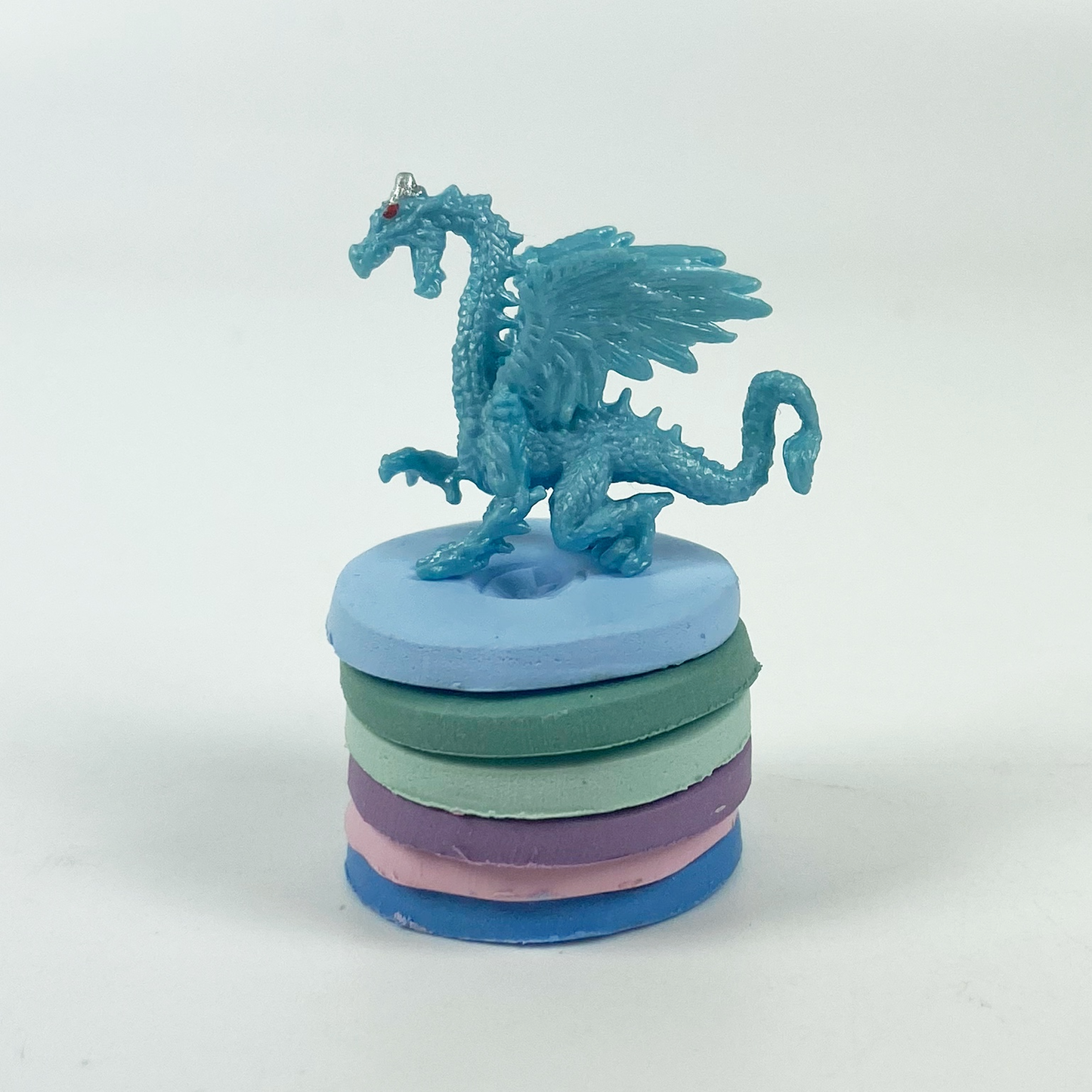 Monet's Lilies Palette Polymer Clay Color Mixing Tutorial blue dragon standing on a stack of clay color sample discs. 